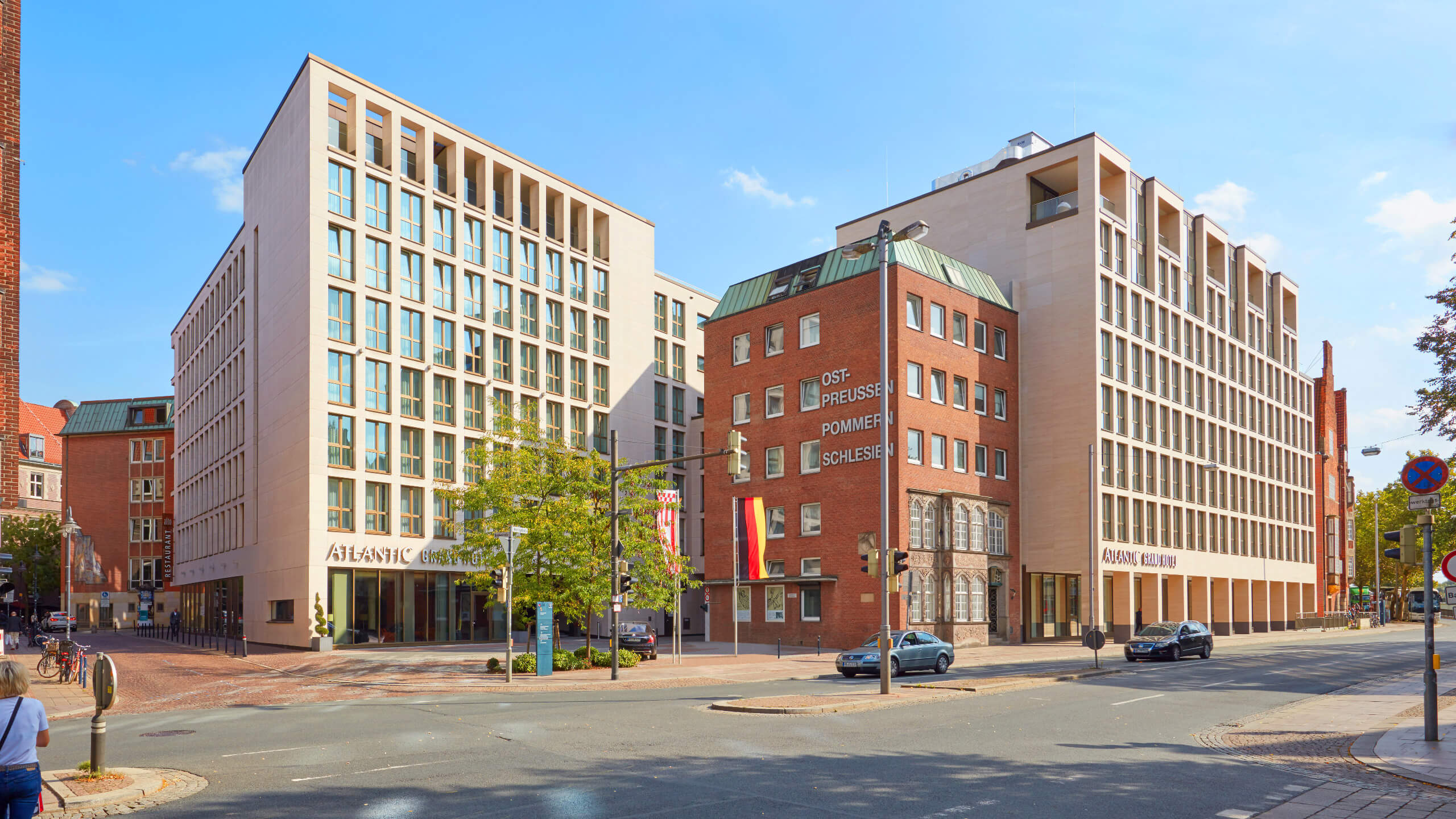 Exterior view of the ATLANTIC Grand Hotel Bremen, modern building with large windows, on a street corner.