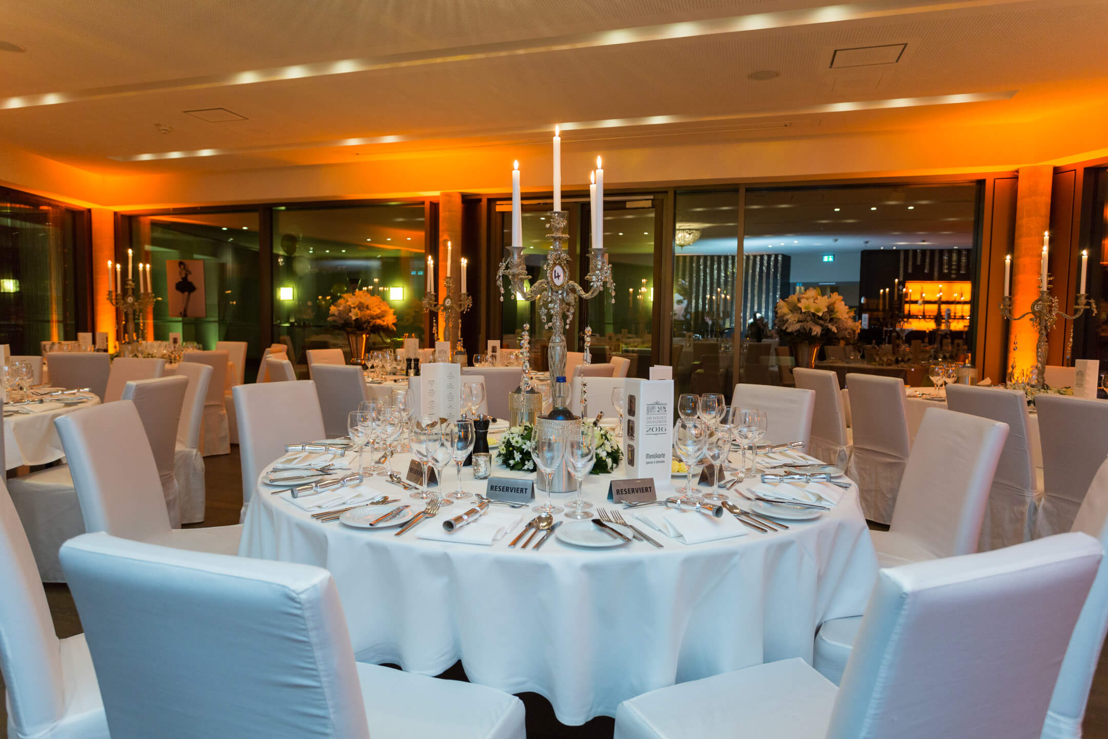 Festively laid, round table on the roof terrace