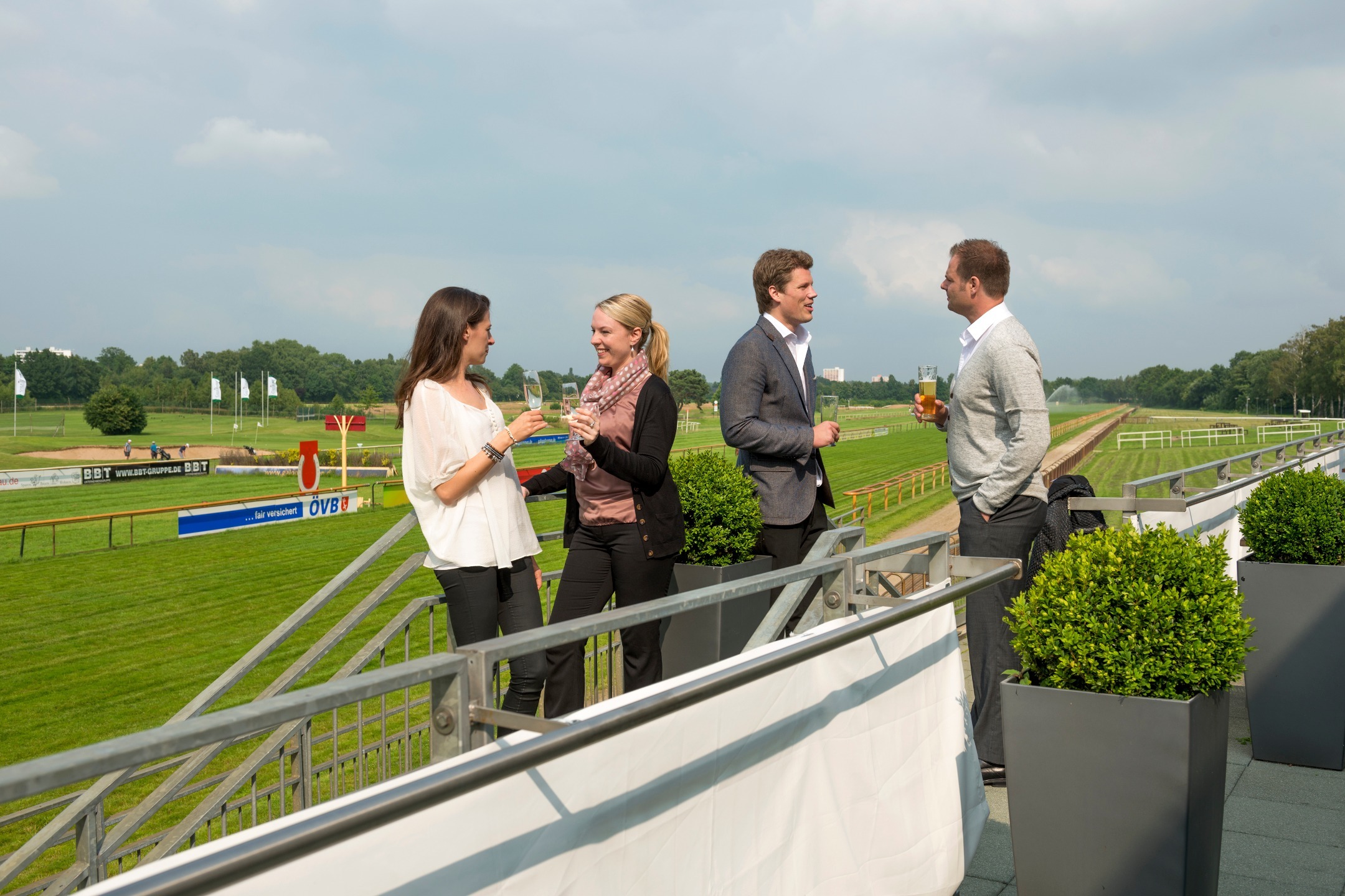 Guests stand relaxed on the terrace