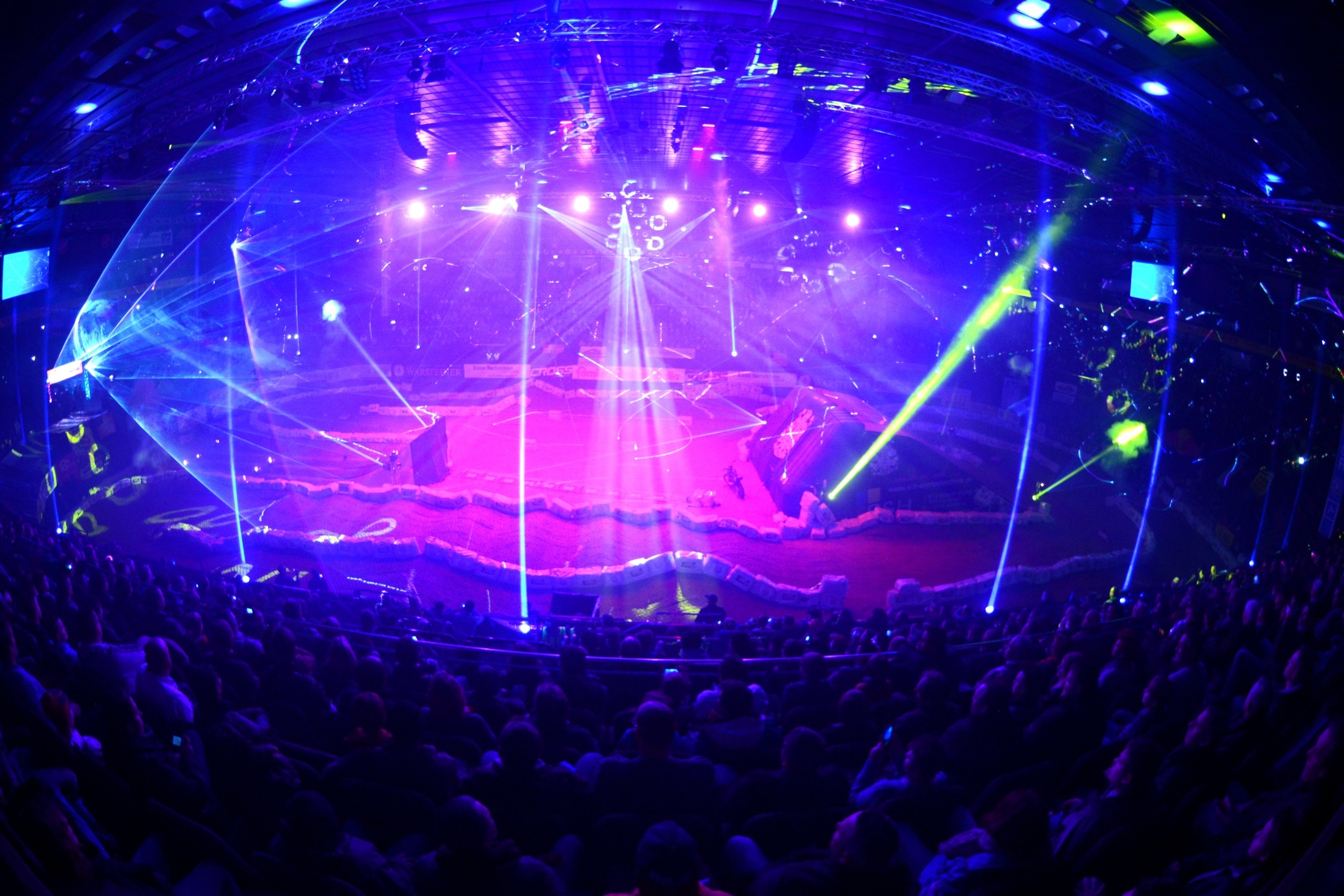 Interior view of the Wunderino Arena Kiel during an event with light show Large event hall with colorful light show and audience in the stands.
