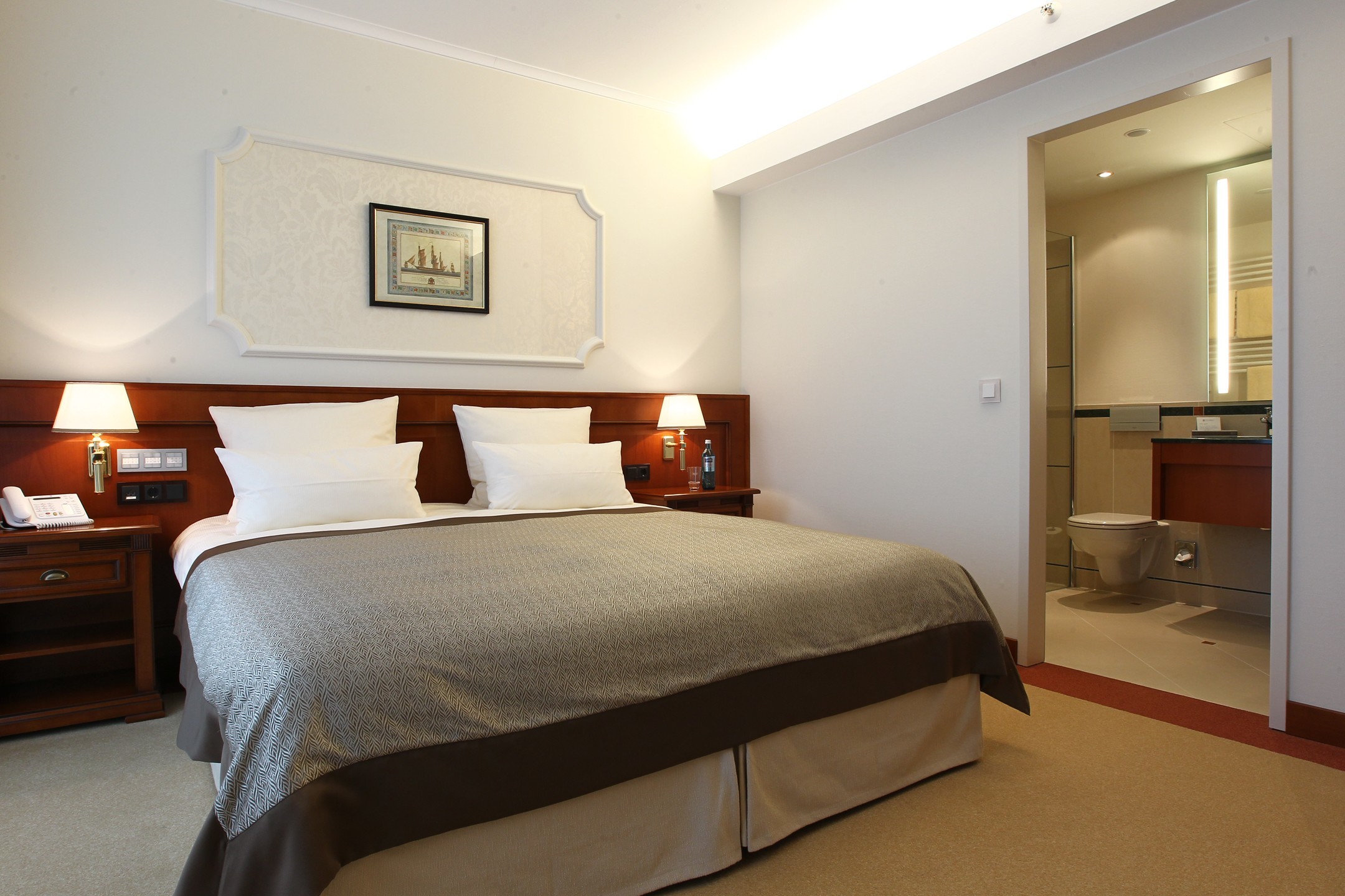 Bedroom with a big bed in the Gorch Fock Suite in the ATLANTIC Hotel Wilhelmshaven