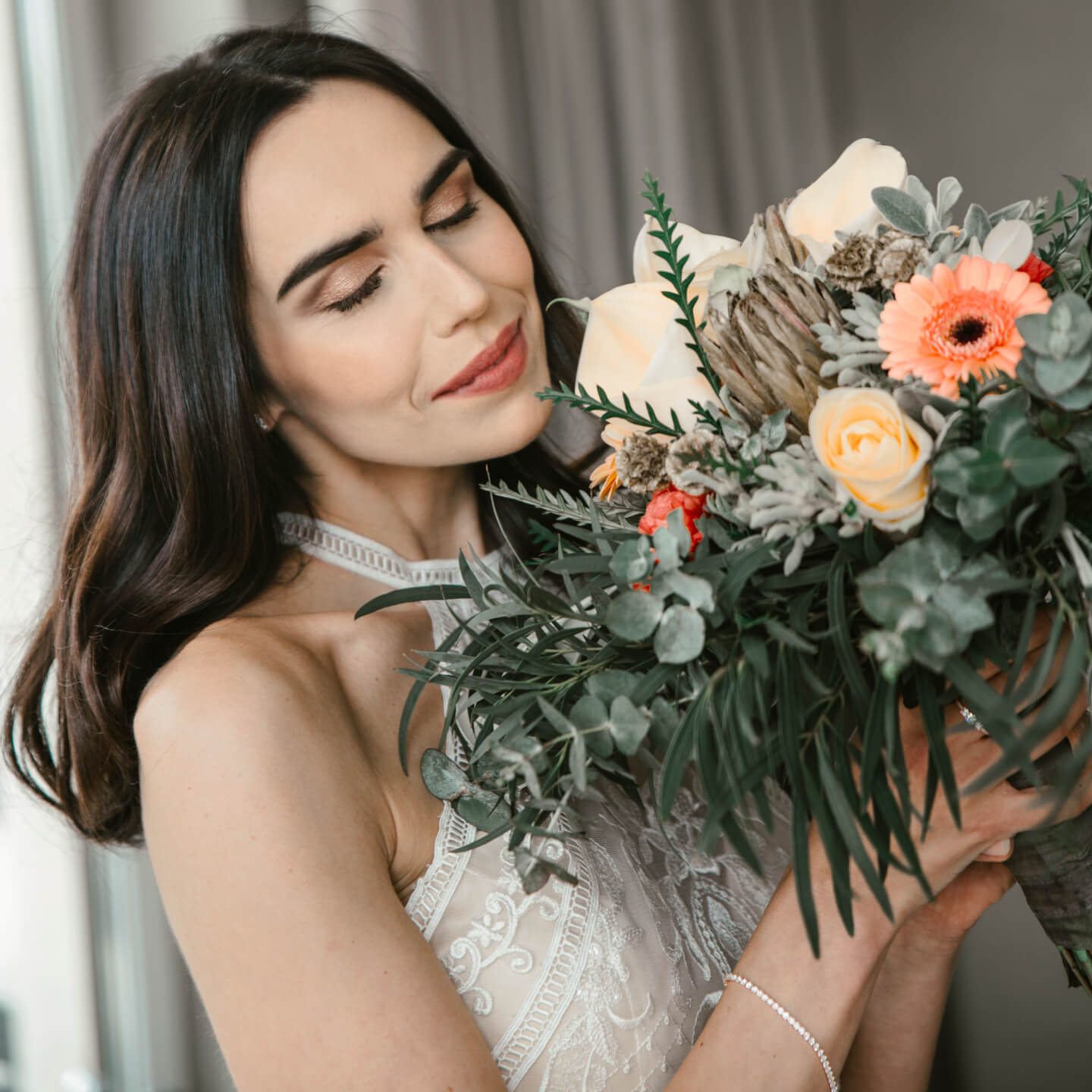 Bride smells on pastel colored bridal flowers