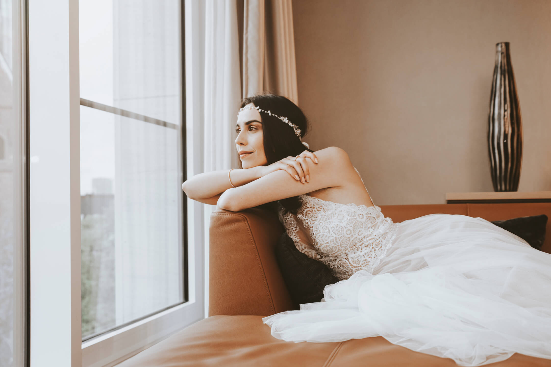 Bride looks dreamy out of the window of the Grand Suite at the ATLANTIC Grand Hotel Bremen