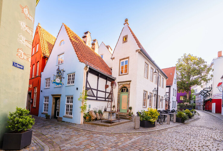 Historic, colorful half-timbered houses in the Schnoor district of Bremen in sunny weather.