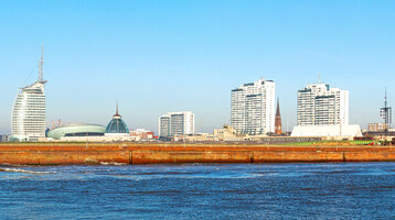 Panorama of Bremerhaven with ATLANTIC Hotel Sail City, lighthouse, harbor and modern cityscape on the water.