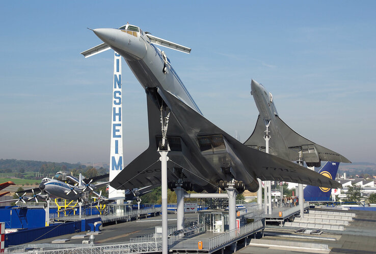 Two airplanes on stilts in the Technik Museum Sinsheim, blue sky in the background.
