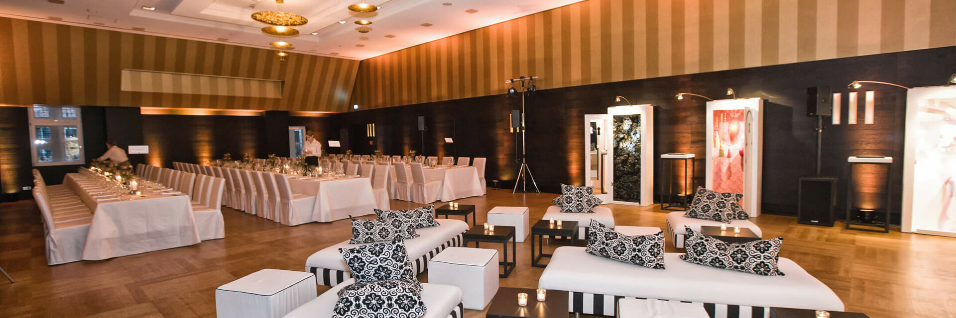 Elegant event room in the ATLANTIC Grand Hotel Bremen with stylish seating and laid tables.
