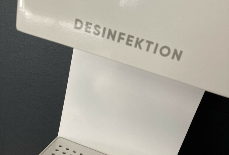 Disinfectant dispenser in the ATLANTIC Hotel Sail City, Bremerhaven, with perforated shelf.