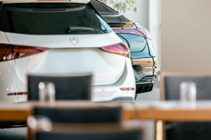 PKW Präsentation im ATLANTIC Hotel Galopprennbahn Zwei Autos parken im Innenbereich des ATLANTIC Hotel Galopprennbahn Bremen, im Vordergrund unscharfe Tische.