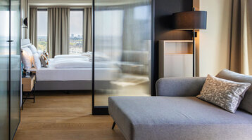 View from the seating area towards the bed and the view outside.