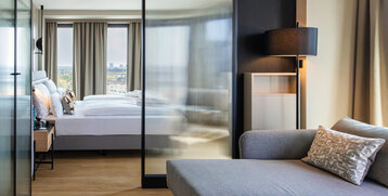 View from the seating area towards the bed and the view outside.