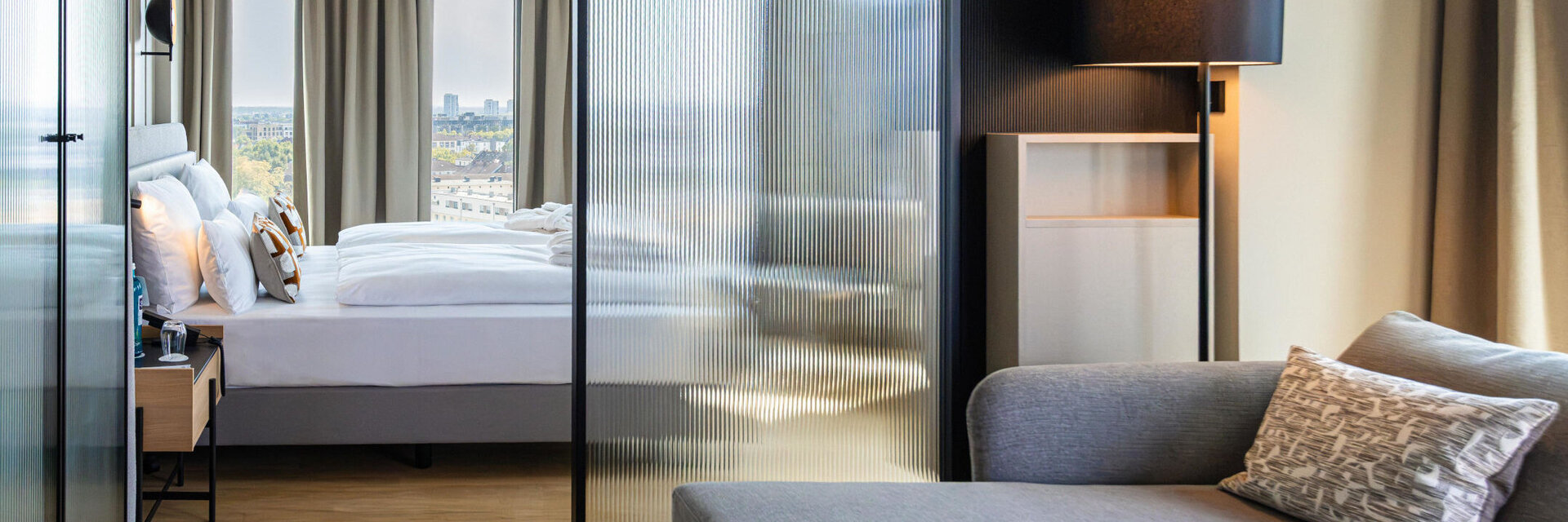 View from the seating area towards the bed and the view outside.