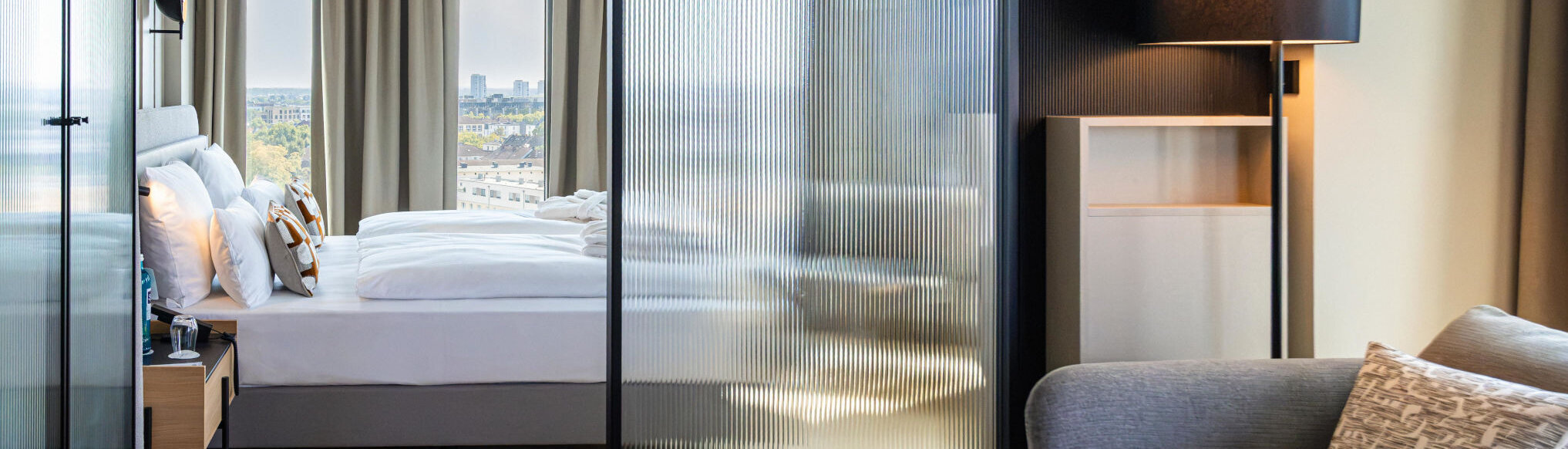 View from the seating area towards the bed and the view outside.