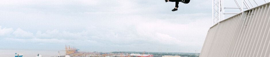 A woman is swinging above the viewing platform at the ATLANTIC Hotel Sail City.
