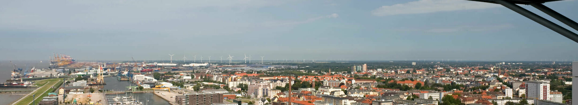 ATLANTIC Hotel Sail City viewing platform View from ATLANTIC Hotel Sail City of Bremerhaven's harbor and city under a clear sky, with visitors on the viewing platform.