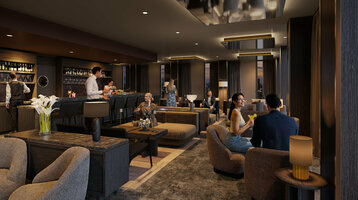 Die stimmungsvolle, moderne Bar im ATLANTIC Hotel Frankfurt, mit indirekter Deckenbeleuchtung, dunkelgrauen Wänden, verschiedenen Sesseln als Sitzmöglichkeiten und Dekoration in dunklen Holztönen.