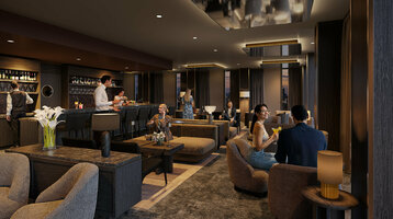 The cosy, modern bar at the ATLANTIC Hotel Frankfurt, featuring indirect ceiling lighting, dark grey walls, a variety of armchairs for seating, and décor in dark wood tones.The cosy, modern bar at the ATLANTIC Hotel Frankfurt, featuring indirect ceiling lighting, dark grey walls, a variety of armchairs for seating, and décor in dark wood tones.