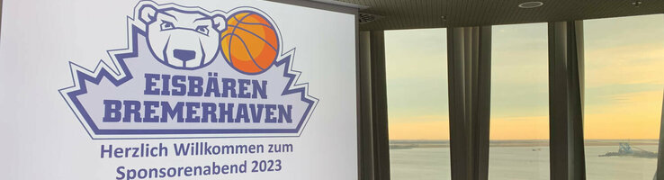 Konferenzraum im ATLANTIC Hotel Sail City mit Blick auf den Sonnenuntergang über dem Wasser, Logo der Eisbären Bremerhaven.