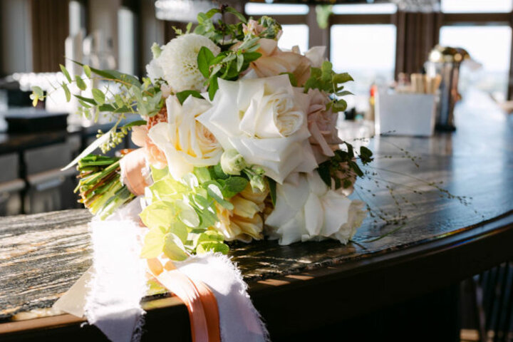 Bouquet of flowers on a stylish bar in the ATLANTIC Hotel Heidelberg, surrounded by elegant interior design.