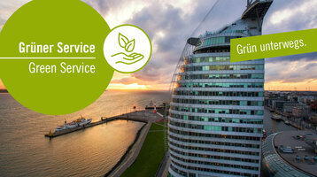 ATLANTIC Hotel Sail City before sunset with green "Green Service" logo and the slogan "Green on the road".