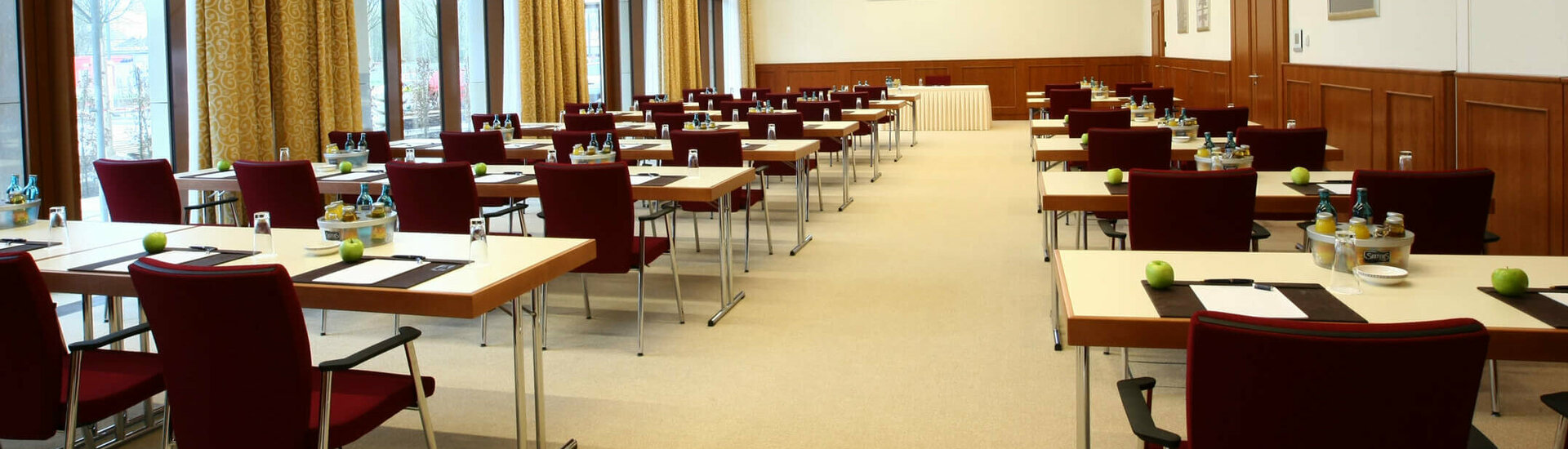 Function room for meetings and events Modern conference room at the ATLANTIC Hotel Wilhelmshaven, with tables, chairs, notepads and drinks.