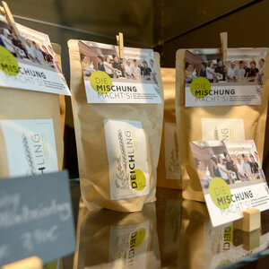 Brown paper bags with "It's all in the mix!" labels on a shelf in the ATLANTIC Hotel Sail City.