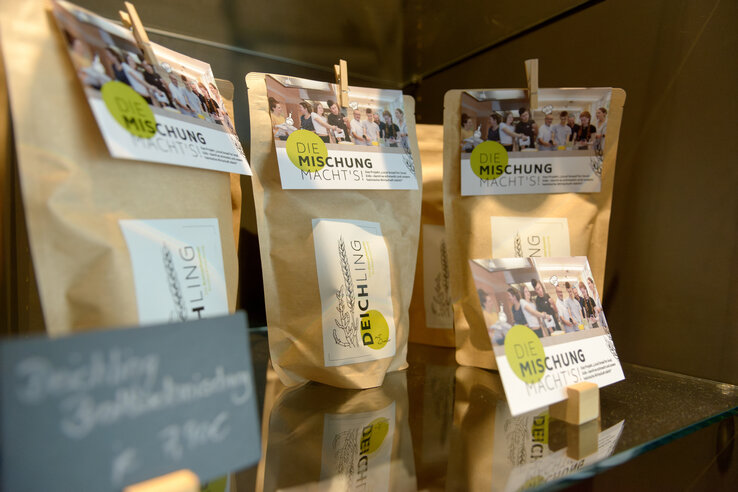 Brown paper bags with "It's all in the mix!" labels on a shelf in the ATLANTIC Hotel Sail City.