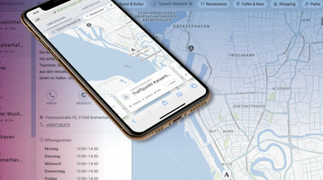 Smartphone shows a map of Bremerhaven with the ATLANTIC Hotel Sail City and the surrounding area.