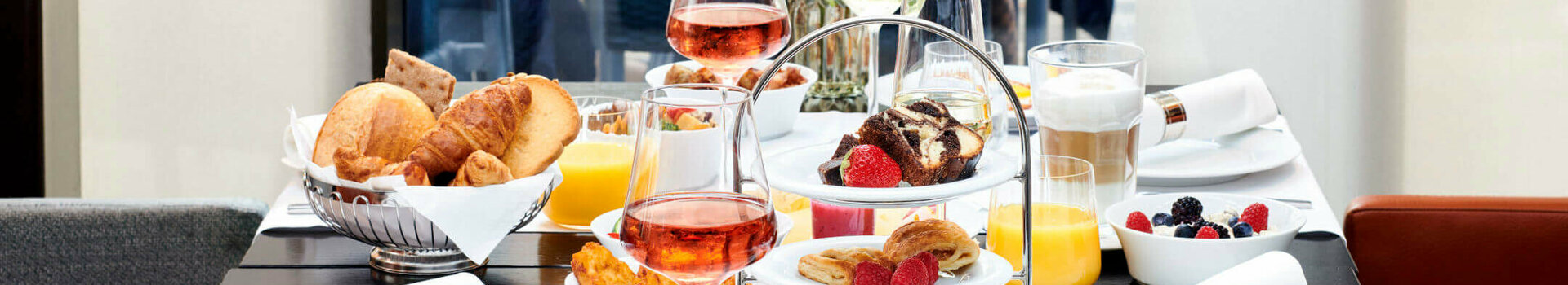 Breakfast tabel in the ATLANTIC Grand Hotel in the old town of Bremen  Elegant breakfast table at the ATLANTIC Grand Hotel Bremen with pastries, fruit, drinks and flower arrangements.
