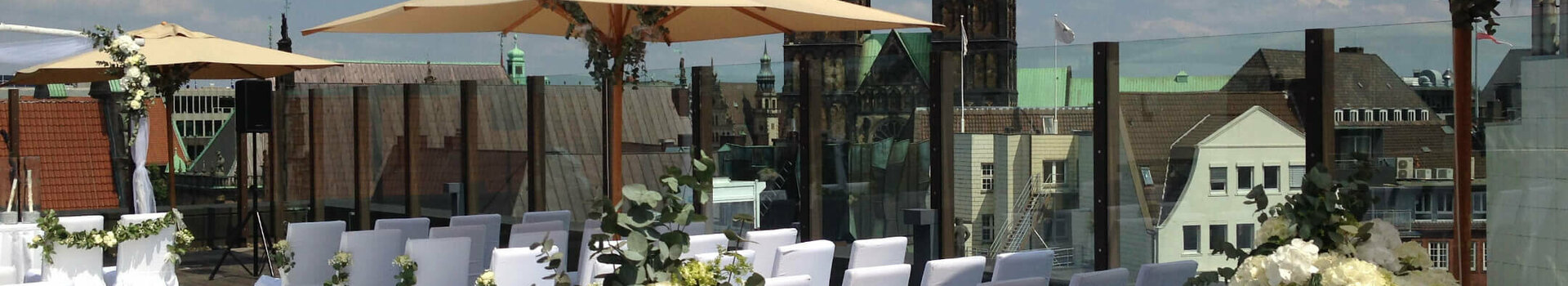 Weddings Celebration at the Roof Lounge Roof terrace of the ATLANTIC Grand Hotel Bremen, festively decorated for an event with a view of church spires.