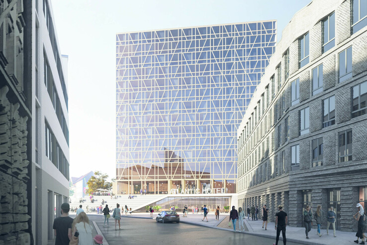 Modern hotel with glass façade, surrounded by old buildings, people walking on the street.