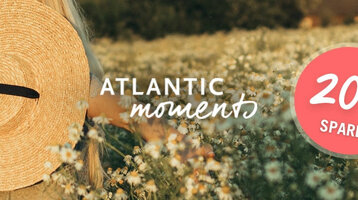 Frau mit Strohhut in Blumenwiese, Text "Atlantic Moments", Rabattangebot "20% sparen" in rotem Kreis.