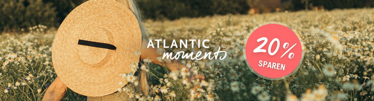 Frau mit Strohhut in Blumenwiese, Text "Atlantic Moments", Rabattangebot "20% sparen" in rotem Kreis.
