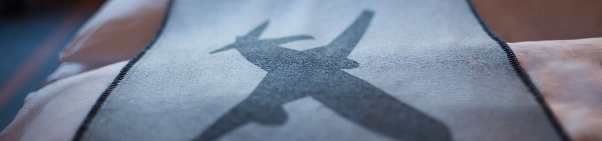 The bedspread in a business room of the ATLANTIC Hotel Airport Bremen Bedspread in the ATLANTIC Hotel Airport Bremen with airplane motif, blurred window view in the background.