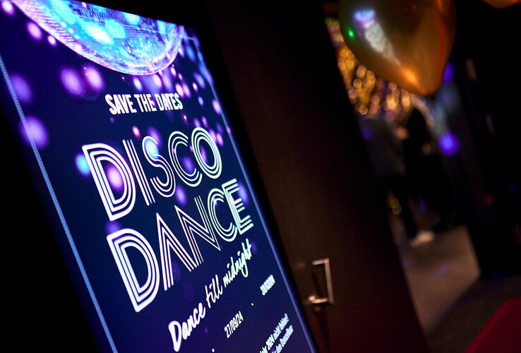 Bright poster at the ATLANTIC Hotel Münster advertises disco event with dancing until midnight.