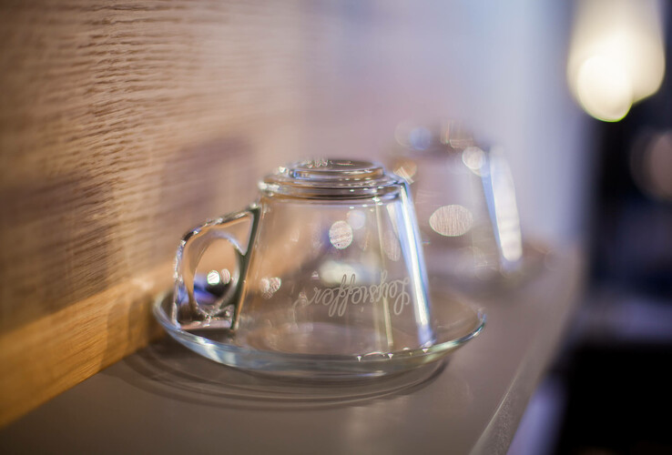 Two upturned glass cups on a tray, softly lit, in the ATLANTIC Hotel Airport Bremen.