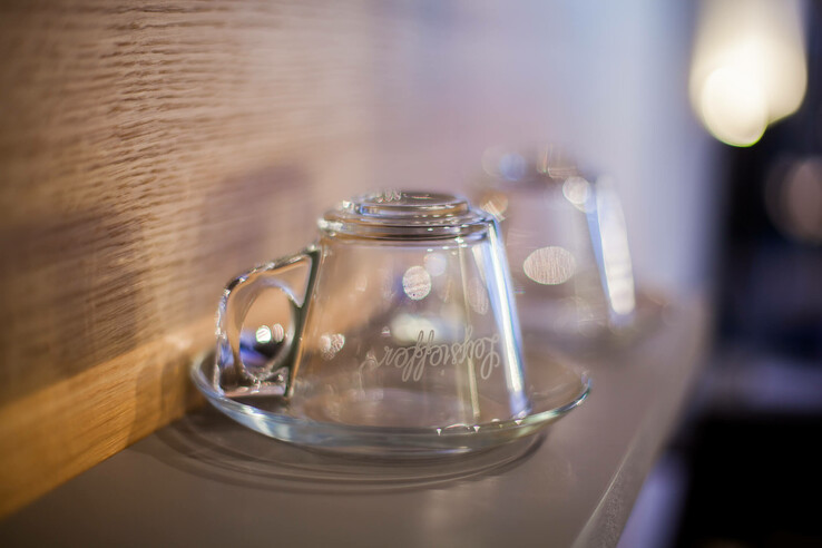 Two upturned glass cups on a tray, softly lit, in the ATLANTIC Hotel Airport Bremen.