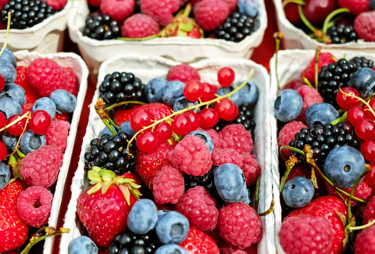 Fresh berry mix in bowls: Raspberries, blackberries, blueberries, strawberries and currants.