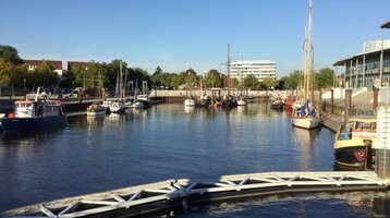 Vegesack harbour © Fritz Rapp Harbor view with boats in the water, surrounded by buildings and trees, under a clear sky in Bremen Vegesack.
