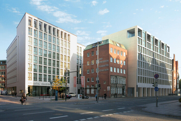 Modern façade of the ATLANTIC Grand Hotel Bremen on a street corner in daylight.