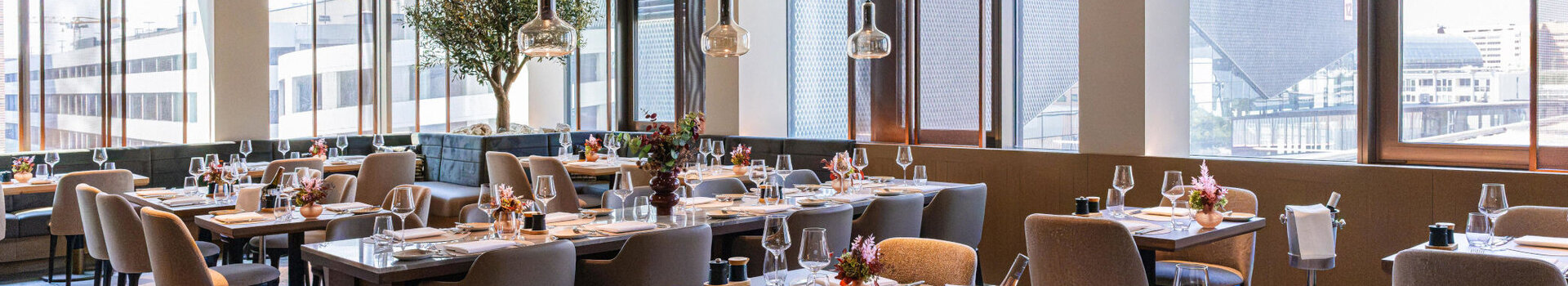 A bright, modern restaurant with a view of the Frankfurt Exhibition Centre.