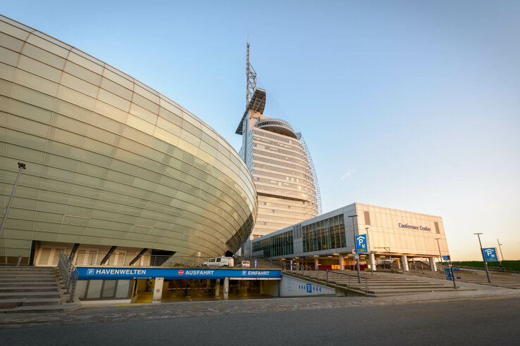 ATLANTIC Hotel Sail City in Bremerhaven, modern high-rise building with curved glass façade and adjoining conference center.