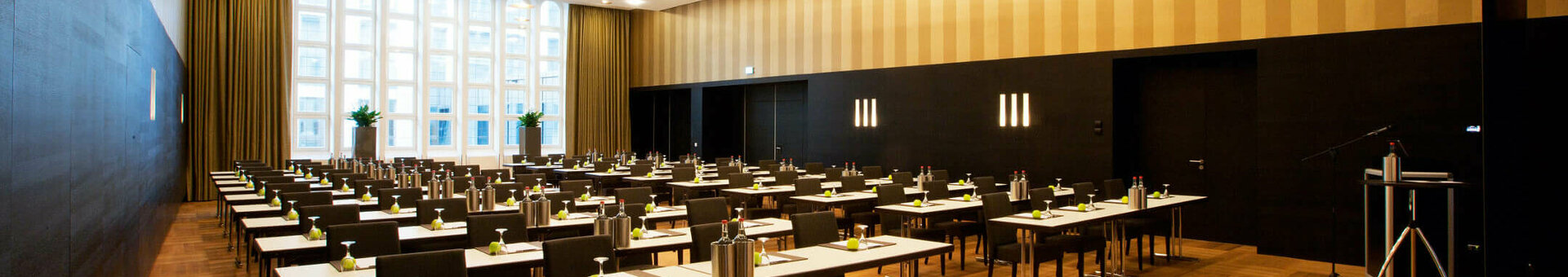 Modern conference room in the ATLANTIC Grand Hotel Bremen with elegant seating and large windows.