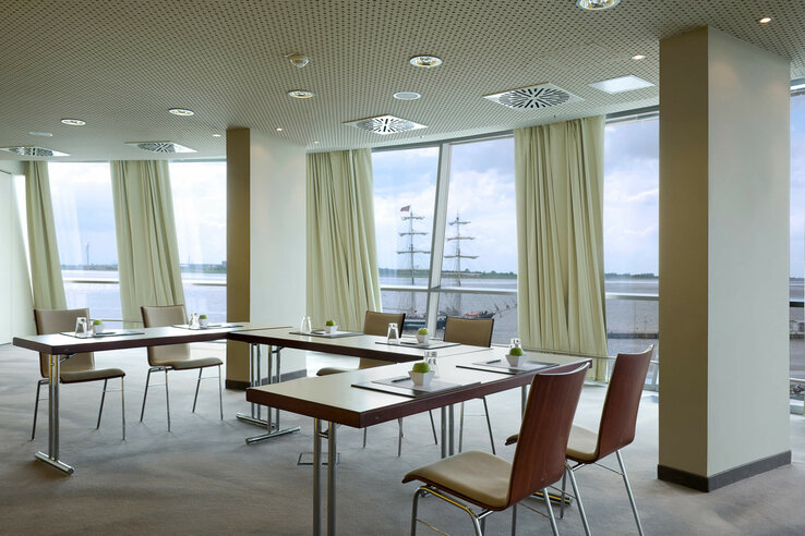 Modern conference room with harbor view at the ATLANTIC Hotel Sail City, Bremerhaven.