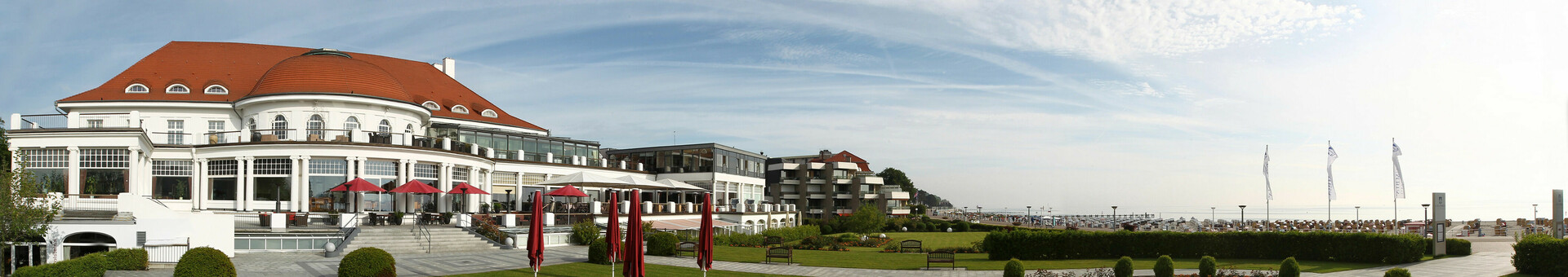 ATLANTIC Grand Hotel Travemünde The ATLANTIC Grand Hotel Travemünde with garden, terrace and view of the Baltic Sea in sunny weather.