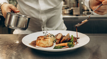 A chef prepares food in a professional kitchen