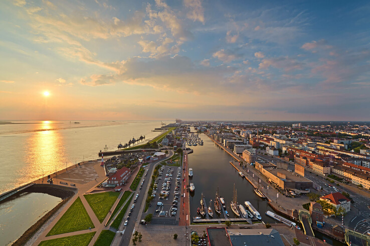 View of Bremerhaven from the ATLANTIC Hotel Sail City at sunset, with harbor, river and city panorama.