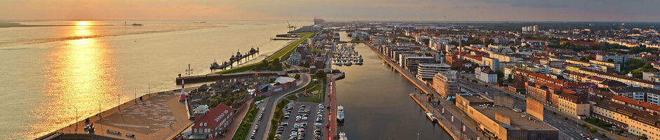 View of Bremerhaven from the ATLANTIC Hotel Sail City at sunset, with harbor, river and city panorama.