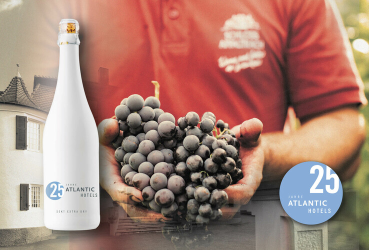 White building, champagne bottle, hands holding grapes, red background, logo "25 years of Atlantic Hotels".