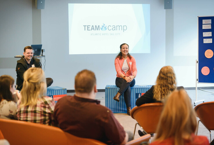 People in a seminar room at the ATLANTIC Hotel Sail City, Bremerhaven, during a presentation.